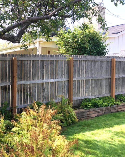 Weathered cedar wood fence post replacement in Denver, Colorado.