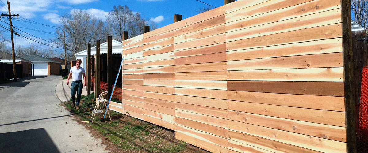 Owner of Fence Repair of Denver, Kelly building a modern horizontal fence in Denver, Colorado.