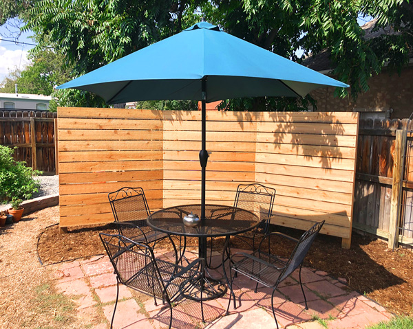 Modern horizontal wood privacy screen wrap around patio with shade in Baker neighborhood in Denver, Colorado.