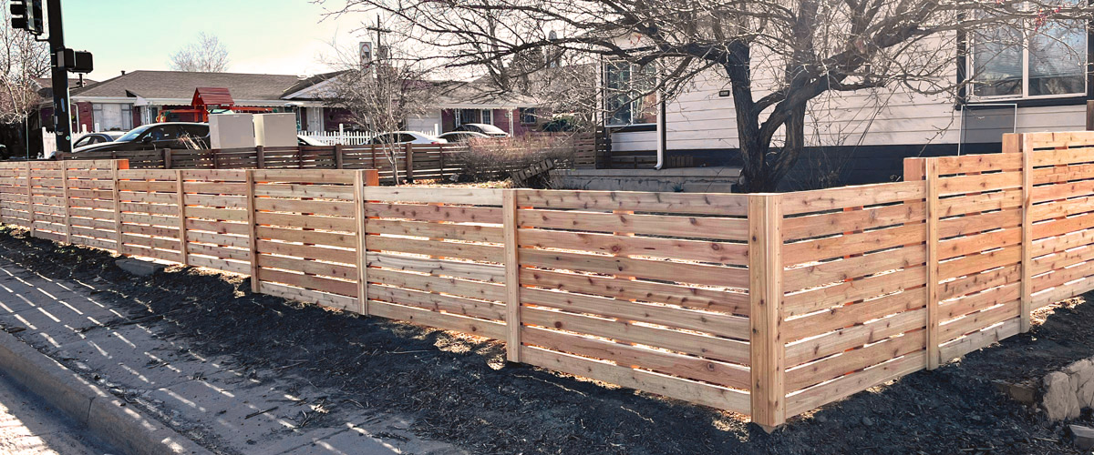 Modern horizontal wood front yard fence from corner in Sloans Lake neighborhood in Denver, Colorado.