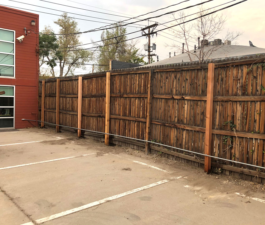 8 foot tall cedar wood fence repair for a business in Denver, Colorado.