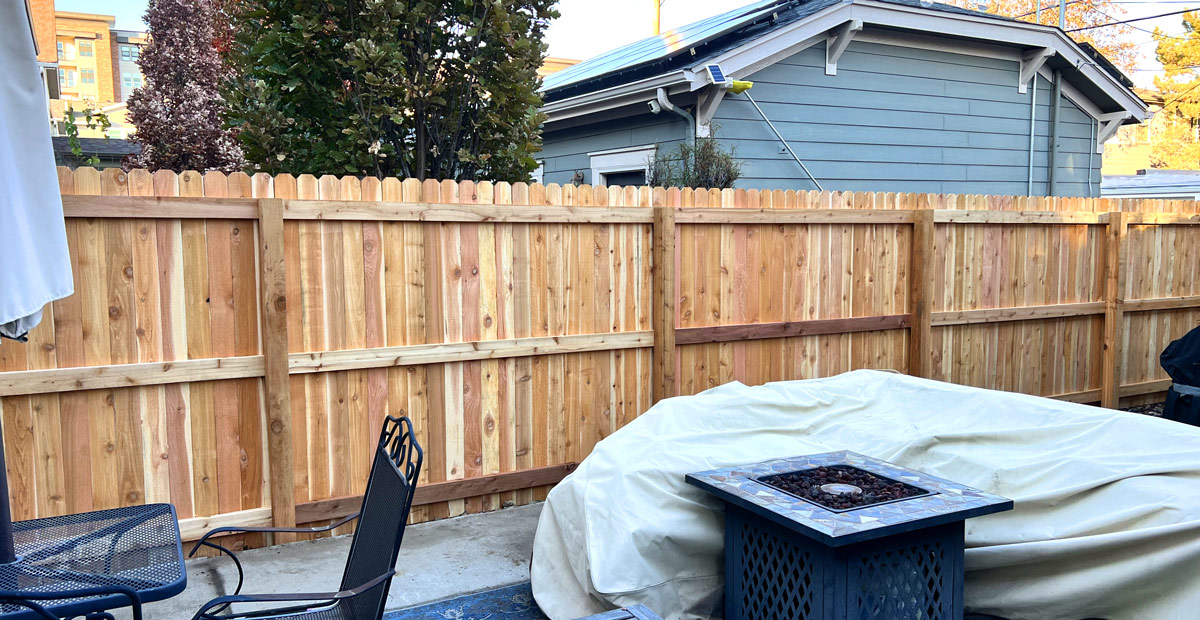 Shared cedar wood privacy fence in South Pearl neighborhood in Denver, Colorado.