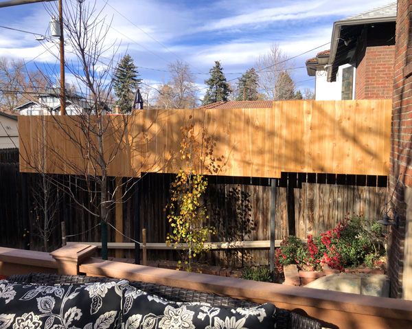 Vertical cedar picket privacy screen with steel posts from patio in Wash Park neighborhood in Denver, Colorado.