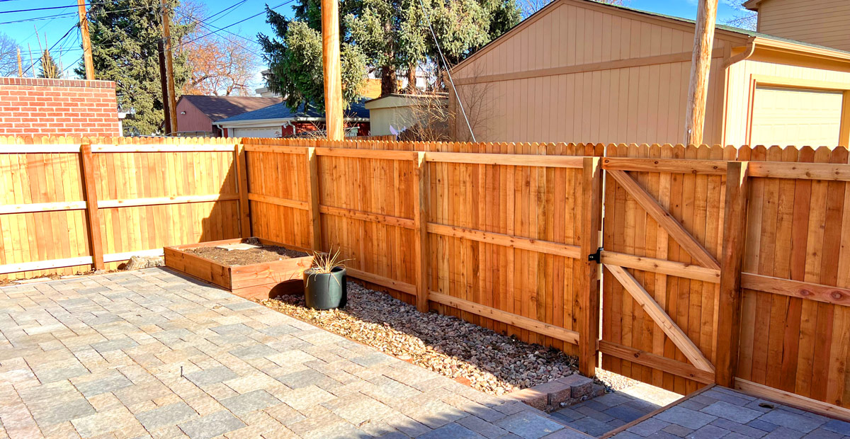 Cedar wood dog ear picket fence along alley in Wheat Ridge, Denver, Colorado.