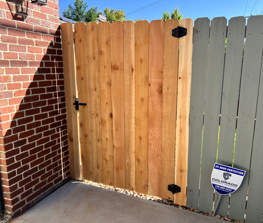 Cedar wood fence gate and post repair with self closing hinges in Denver, Colorado.