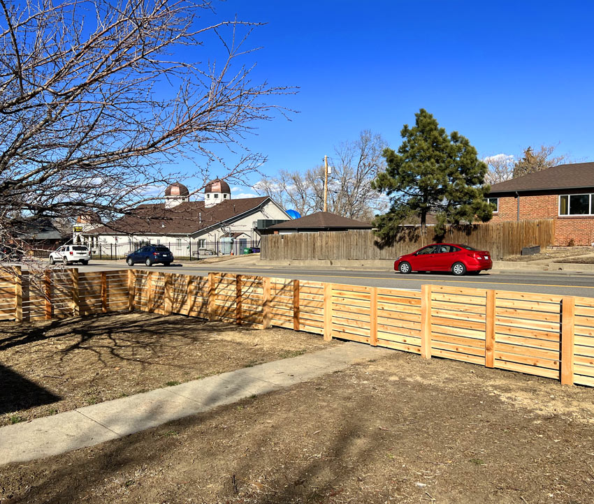 Modern horizontal wood front yard fence from inside in Sloans Lake neighborhood in Denver, Colorado.