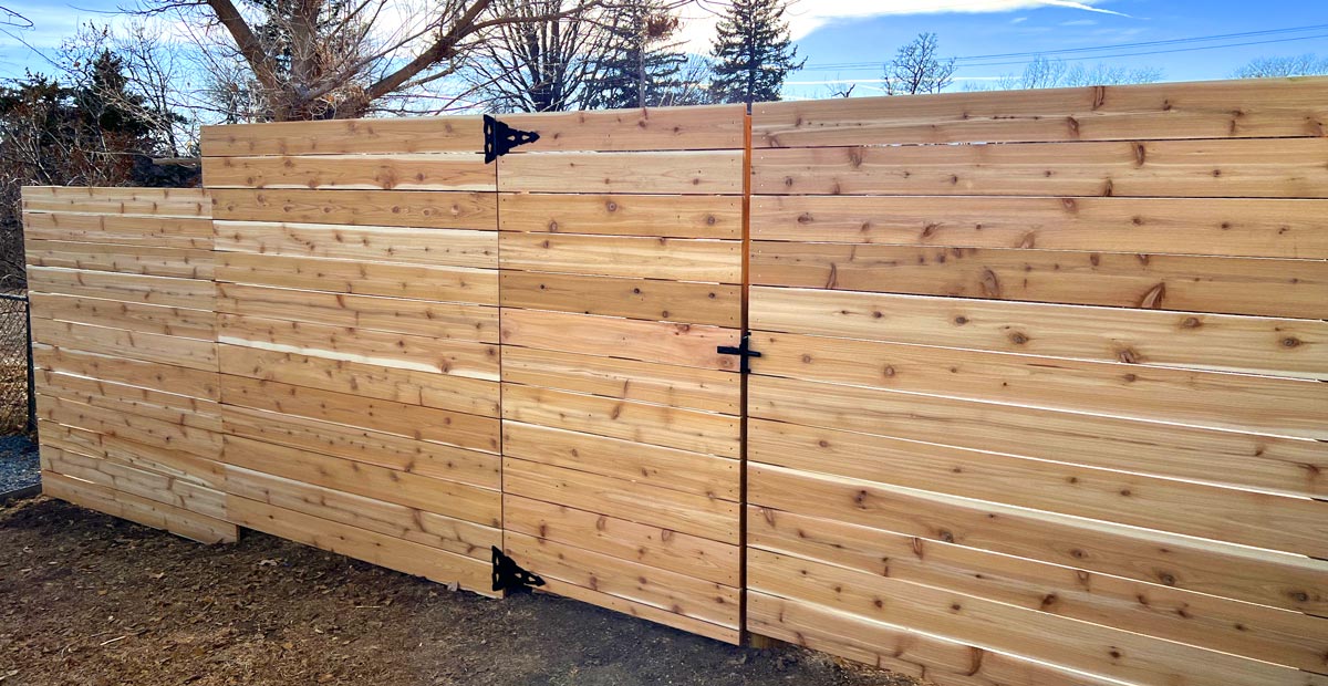 Modern horizontal wood fence with gate in Ruby Hill neighborhood in Denver, Colorado.