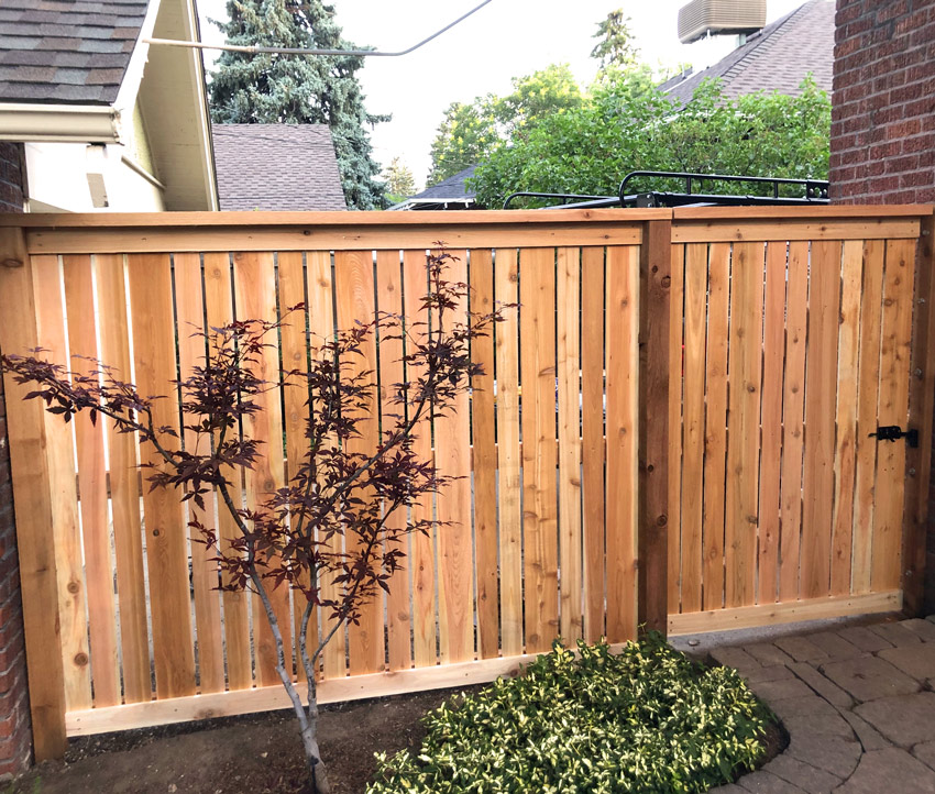 Cedar wood spaced picket fence with top cap and trim board in Congress Park neighborhood in Denver, Colorado.