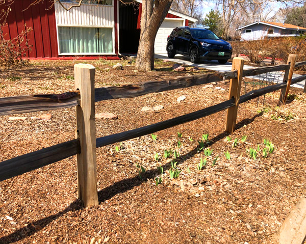 Split rail post repair in Denver, Colorado.