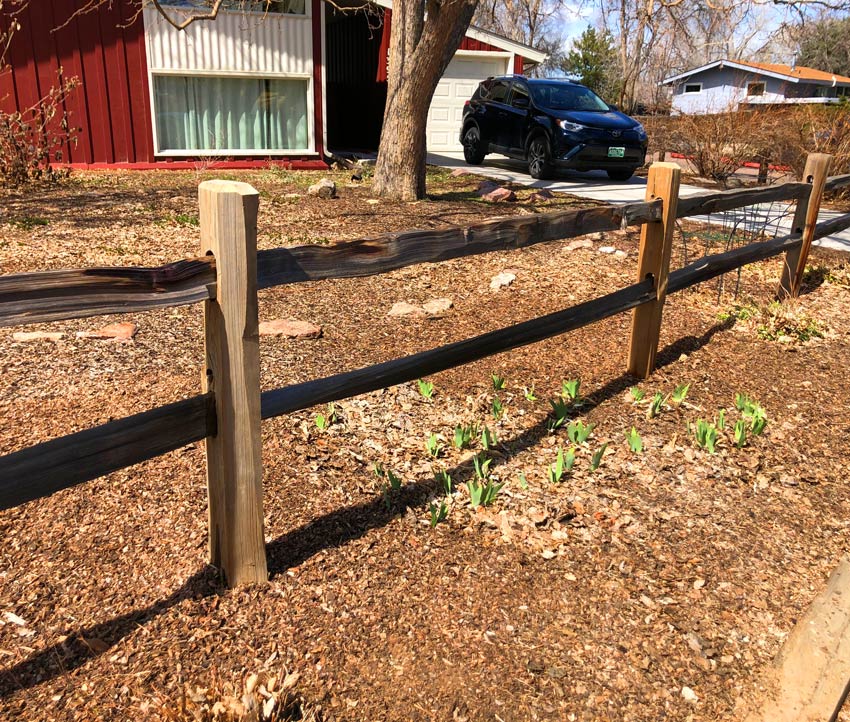 Cedar wood split rail post repair in Denver, Colorado.