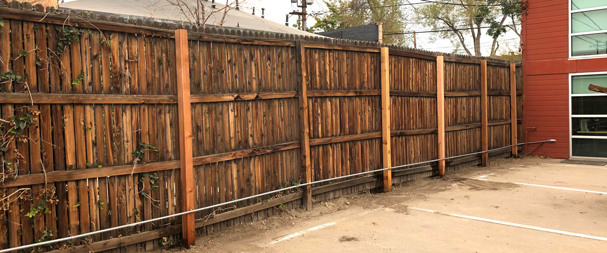 8' tall fence post repair for business in Denver, Colorado.