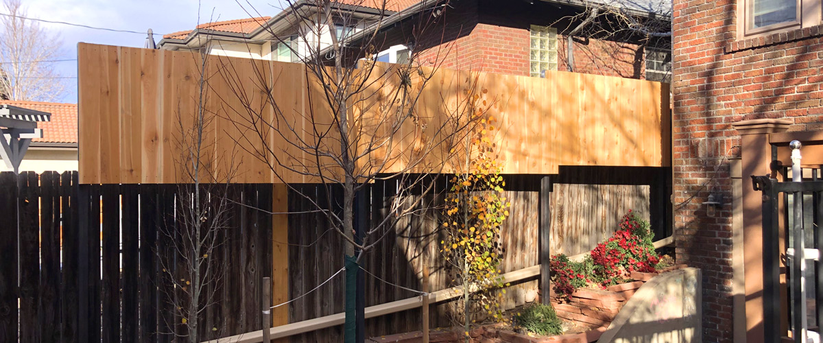 Vertical cedar picket privacy screen with steel posts in Wash Park neighborhood in Denver, Colorado.