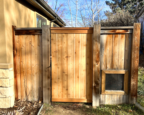 Cedar wood fence gate repair with top cap and trim boards in Denver, Colorado.