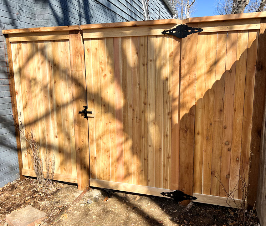 New cedar wood picket gate section, with top cap and fascia or trim boards in Denver, Colorado.