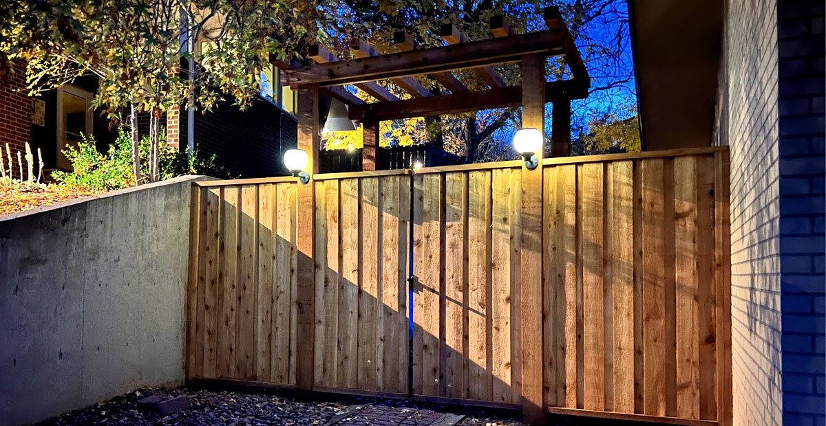 classic_wood_arbor_fence_design_denver_colorado Custom design wood arbor fence gate in Lakewood, Colorado at night with lights