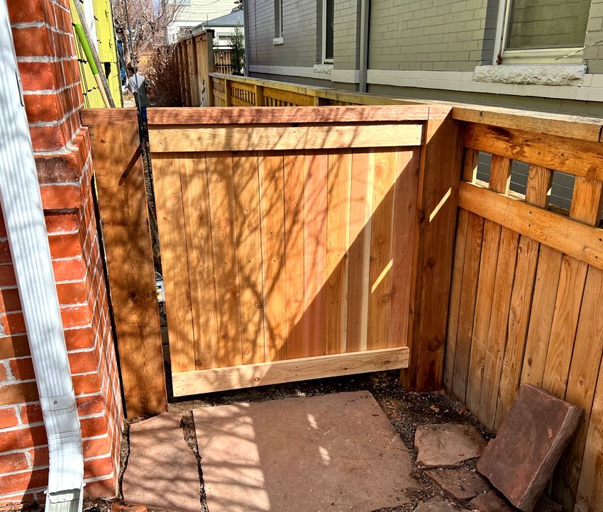 Wood fence gate repair with top cap and trim board in Denver, Colorado